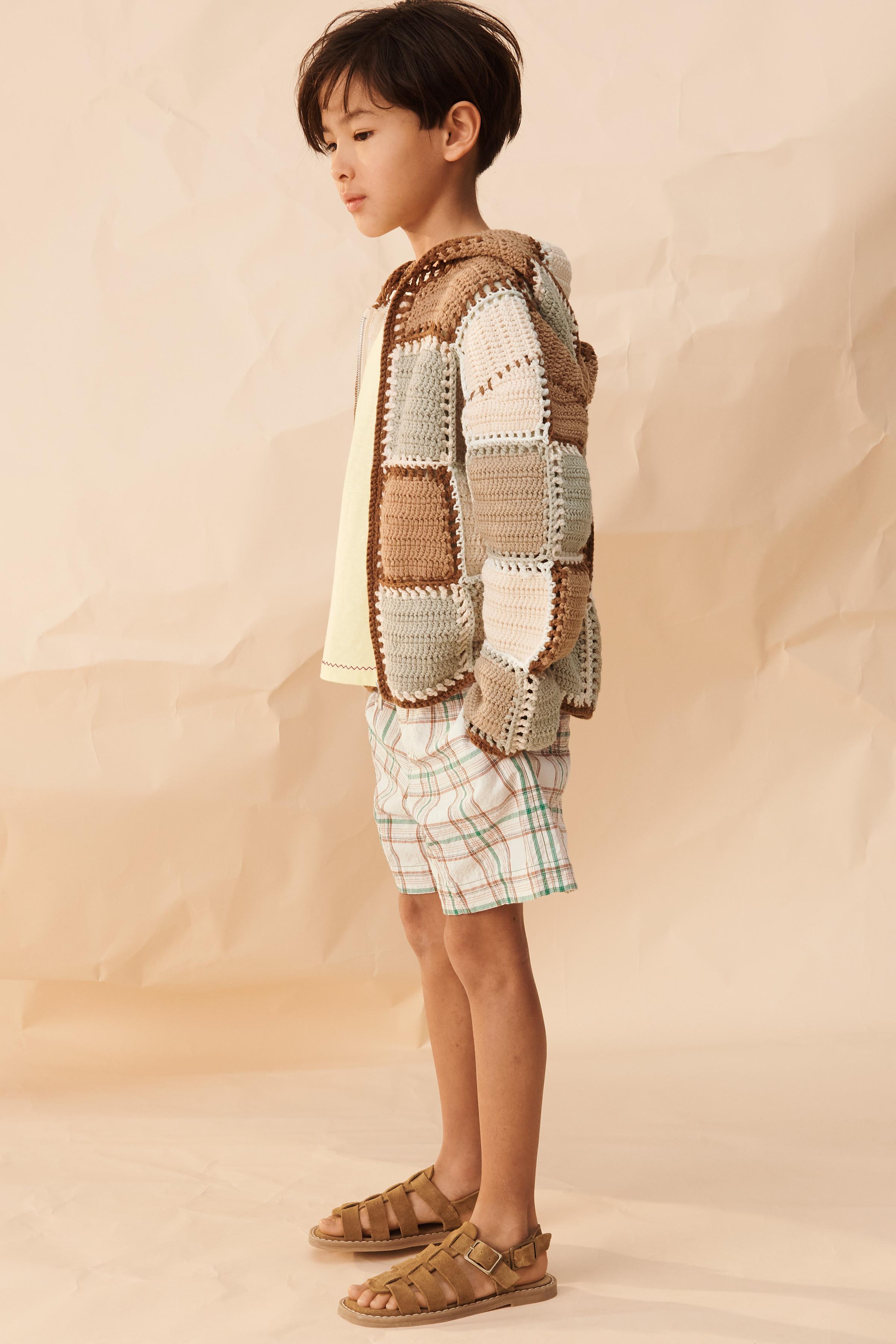 GILET EN MAILLE CROCHET À CAPUCHE ÉDITION LIMITÉE